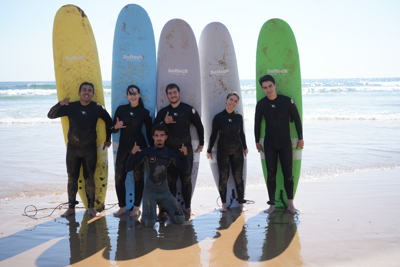 Surfers walking out to the water at Amlal